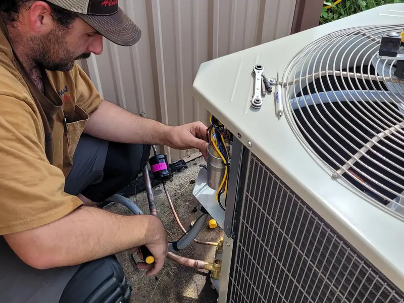 Adams technician working on an AC condenser